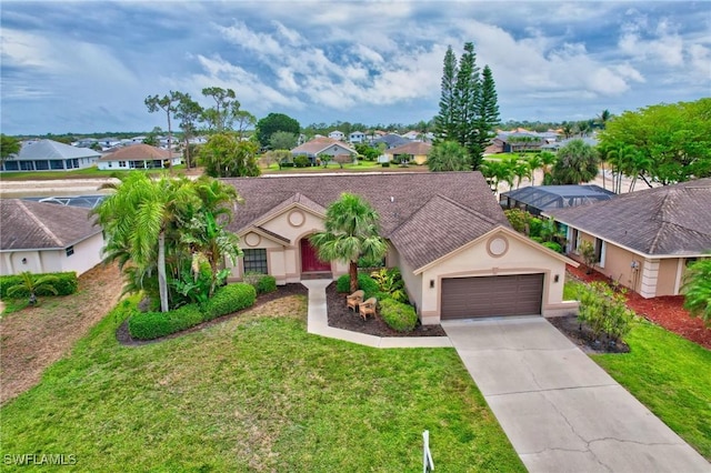 24979 Paradise Rd, Bonita Springs, FL 34135 - view of front of property with a residential view, an attached garage, driveway, and a front lawn