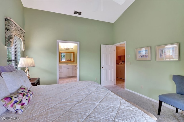 24979 Paradise Rd, Bonita Springs, FL 34135 - carpeted bedroom featuring high vaulted ceiling, baseboards, ensuite bathroom, and washer / dryer