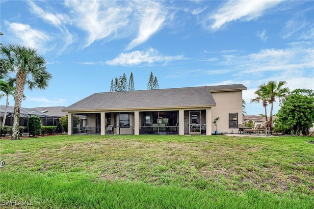 24979 Paradise Rd, Bonita Springs, FL 34135 - back of house featuring a sunroom, a lawn, and stucco siding