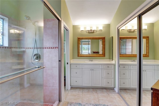 24979 Paradise Rd, Bonita Springs, FL 34135 - bathroom with a shower stall, two vanities, plenty of natural light, and tile patterned flooring