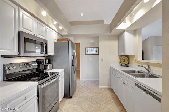 24979 Paradise Rd, Bonita Springs, FL 34135 - kitchen with stainless steel appliances, a sink, white cabinetry, and light tile patterned flooring