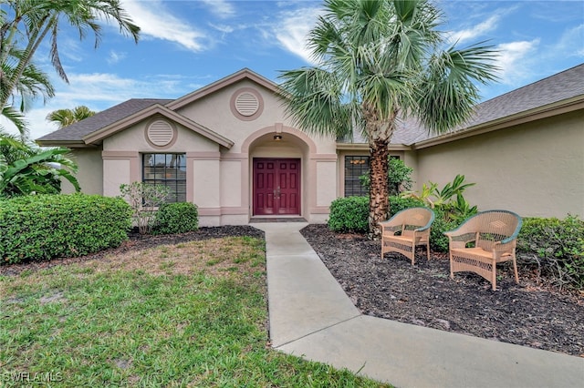 24979 Paradise Rd, Bonita Springs, FL 34135 - view of exterior entry featuring stucco siding
