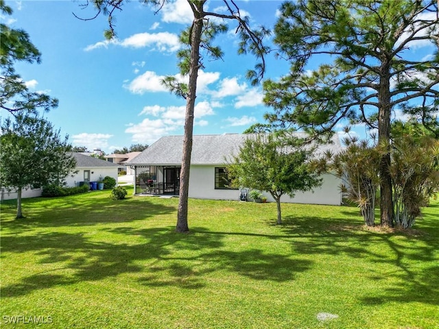 15138 Sam Snead Ln, North Fort Myers, FL 33917 - view of green lawn featuring a sunroom