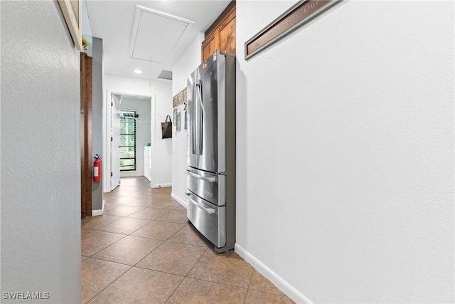 15138 Sam Snead Ln, North Fort Myers, FL 33917 - hallway featuring attic access, light tile patterned flooring, baseboards, and recessed lighting