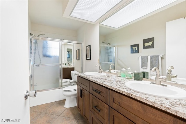 15138 Sam Snead Ln, North Fort Myers, FL 33917 - full bath with toilet, tile patterned flooring, double vanity, and bath / shower combo with glass door