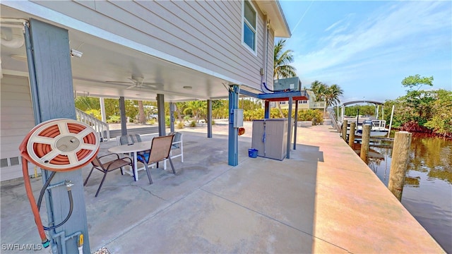 8161 Moyer Ln, Bokeelia, FL 33922 - view of patio with a ceiling fan, a water view, and a boat dock