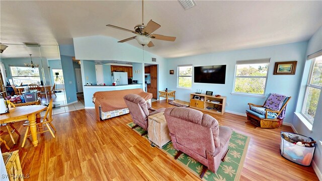 8161 Moyer Ln, Bokeelia, FL 33922 - living area featuring ceiling fan, light wood finished floors, vaulted ceiling, and baseboards