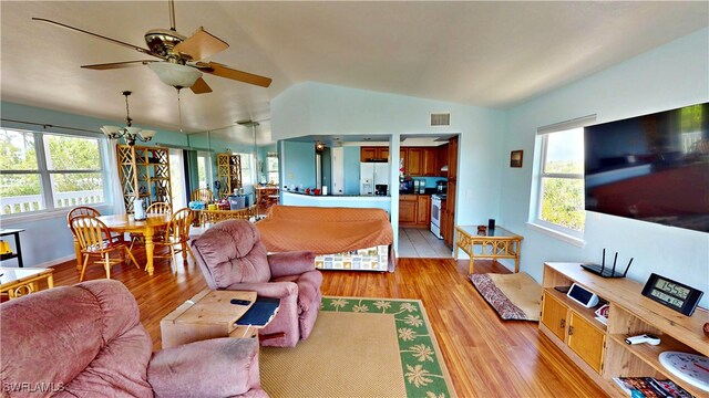 8161 Moyer Ln, Bokeelia, FL 33922 - living room with vaulted ceiling, light wood-style floors, and ceiling fan