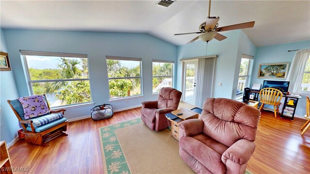 8161 Moyer Ln, Bokeelia, FL 33922 - living room with lofted ceiling, a ceiling fan, wood finished floors, and baseboards