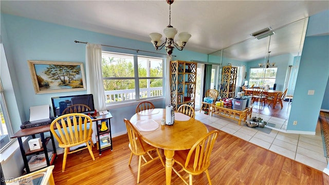 8161 Moyer Ln, Bokeelia, FL 33922 - dining space featuring a chandelier, baseboards, and tile patterned flooring