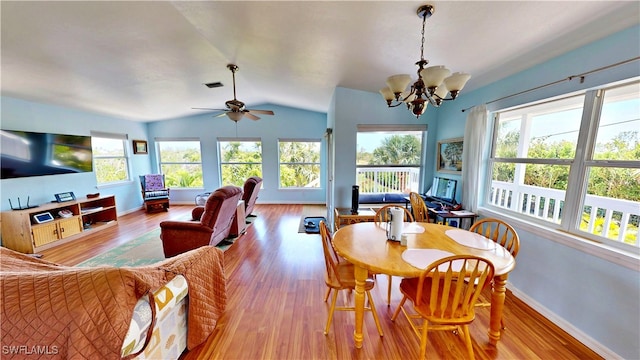 8161 Moyer Ln, Bokeelia, FL 33922 - dining room featuring healthy amount of natural light, a chandelier, vaulted ceiling, and wood finished floors