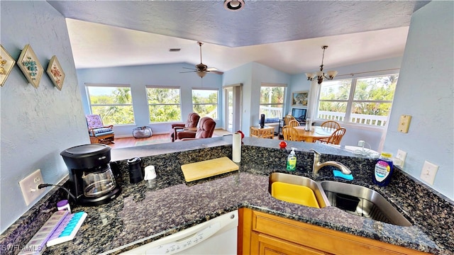 8161 Moyer Ln, Bokeelia, FL 33922 - kitchen with a textured wall, a chandelier, vaulted ceiling, a sink, and dark stone counters