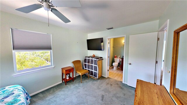 8161 Moyer Ln, Bokeelia, FL 33922 - carpeted bedroom with baseboards, ensuite bathroom, and a ceiling fan