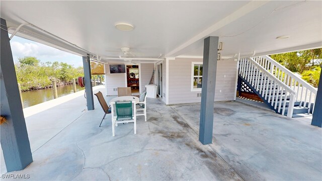8161 Moyer Ln, Bokeelia, FL 33922 - view of patio with a ceiling fan, outdoor dining area, and stairs
