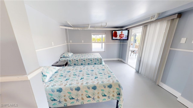 8161 Moyer Ln, Bokeelia, FL 33922 - bedroom with concrete floors, access to outside, and baseboards