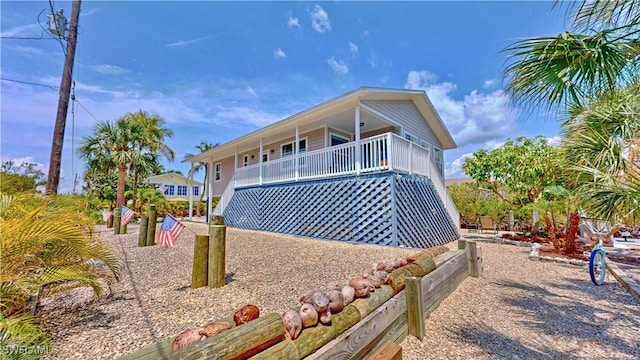 8161 Moyer Ln, Bokeelia, FL 33922 - view of side of property featuring covered porch and stairs