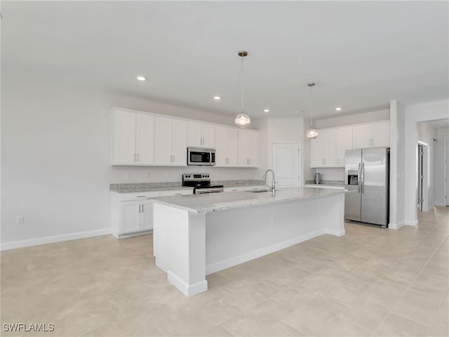 kitchen with appliances with stainless steel finishes, a sink, white cabinets, recessed lighting, and baseboards