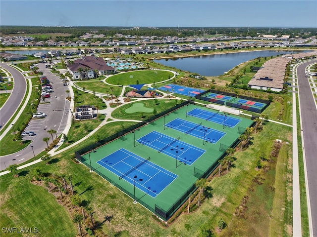 aerial perspective of suburban area with a nearby body of water