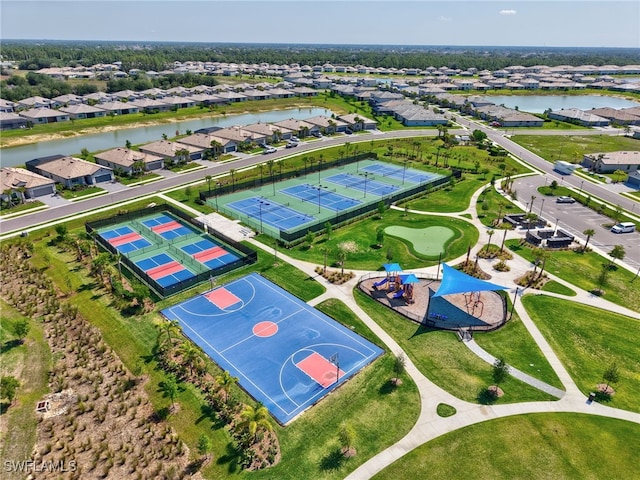 aerial view of residential area featuring a large body of water