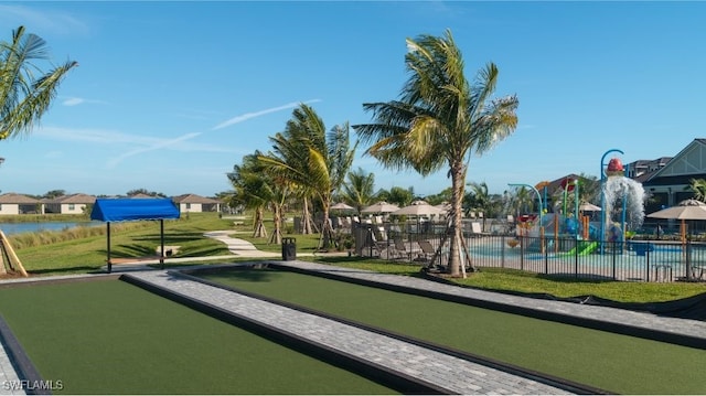 view of property's community featuring a game area and fence