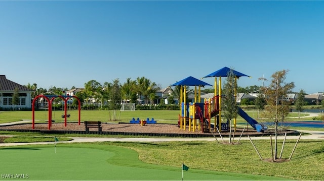 community playground featuring an area to practice putting and a lawn