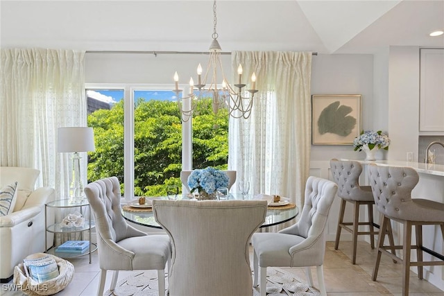 dining room with a chandelier and light tile patterned flooring