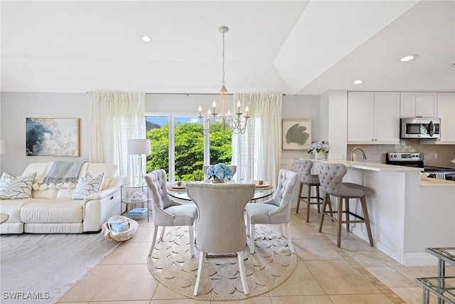 dining space with a chandelier, light tile patterned floors, and recessed lighting