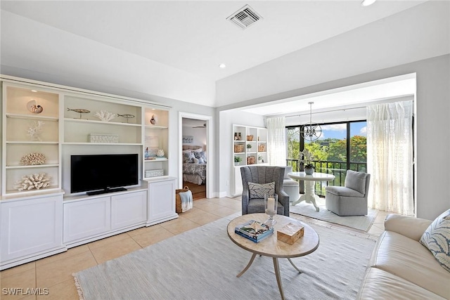 living room with light tile patterned floors, a chandelier, built in shelves, and recessed lighting