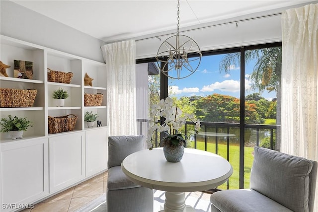 dining room with a chandelier, light tile patterned floors, and a water view
