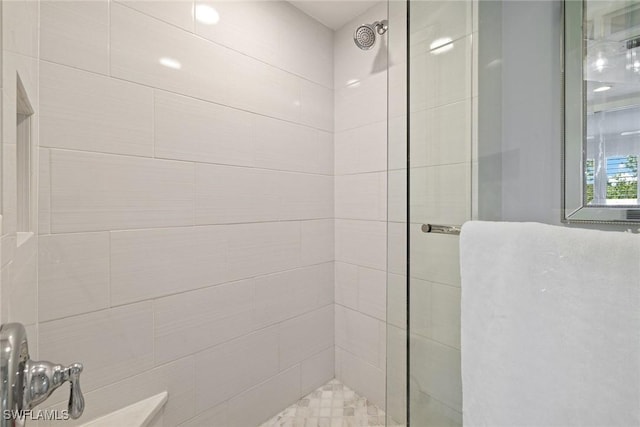 bathroom with a tile shower