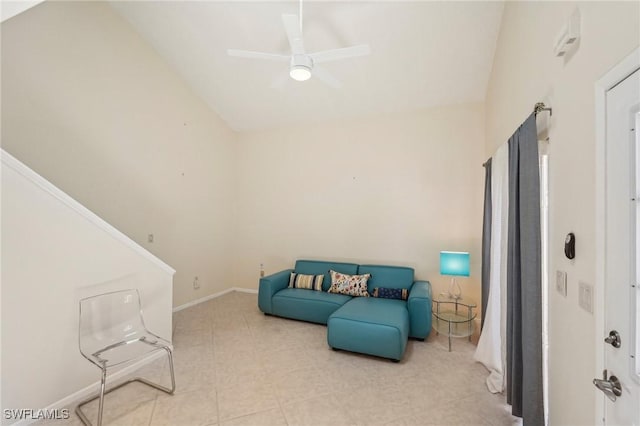 living area with vaulted ceiling, a ceiling fan, tile patterned flooring, and baseboards