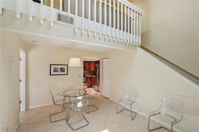 staircase with tile patterned flooring and baseboards