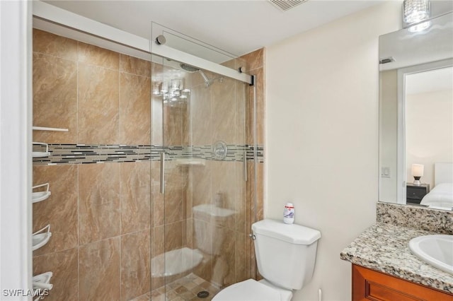 full bath featuring a stall shower, vanity, and toilet