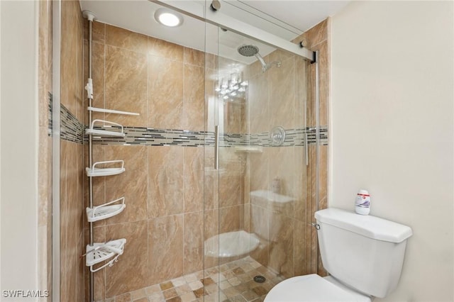 full bathroom with toilet and a shower stall