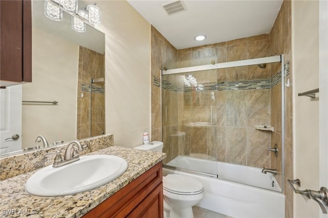 full bath featuring toilet, combined bath / shower with glass door, and vanity