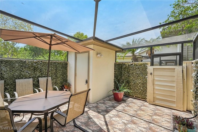 view of patio / terrace featuring outdoor dining space, fence, an outdoor structure, and a shed