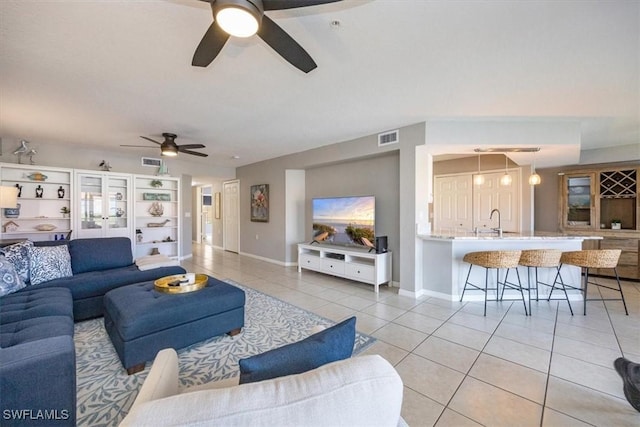 26740 Rosewood Pointe Ln Unit 102, Bonita Springs, FL 34135 - living room with light tile patterned flooring, a ceiling fan, and baseboards