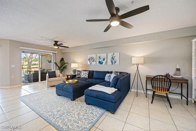 26740 Rosewood Pointe Ln Unit 102, Bonita Springs, FL 34135 - living room featuring a ceiling fan, light tile patterned floors, and baseboards