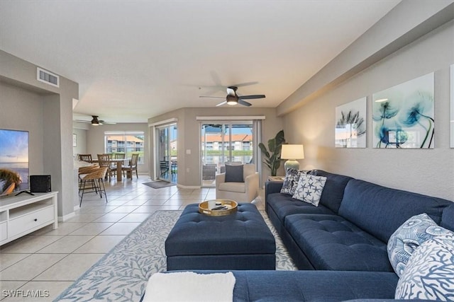 26740 Rosewood Pointe Ln Unit 102, Bonita Springs, FL 34135 - living area with light tile patterned flooring, ceiling fan, plenty of natural light, and baseboards