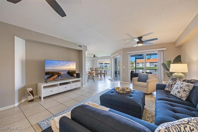 26740 Rosewood Pointe Ln Unit 102, Bonita Springs, FL 34135 - tiled living area featuring ceiling fan, baseboards, and a textured ceiling