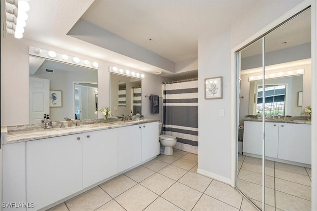 26740 Rosewood Pointe Ln Unit 102, Bonita Springs, FL 34135 - full bath featuring tile patterned flooring, toilet, vanity, baseboards, and a shower with curtain