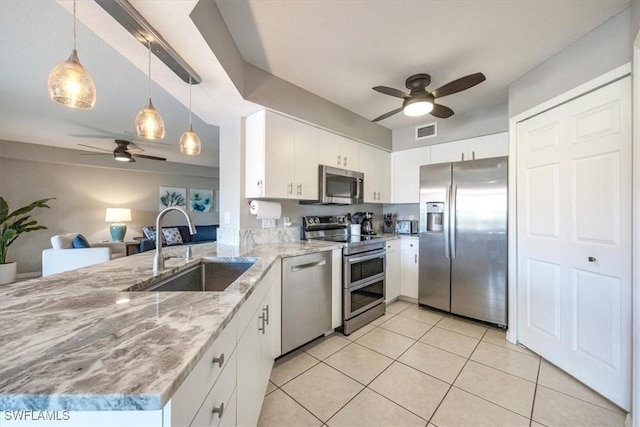 26740 Rosewood Pointe Ln Unit 102, Bonita Springs, FL 34135 - kitchen featuring stainless steel appliances, ceiling fan, a sink, a peninsula, and light tile patterned floors