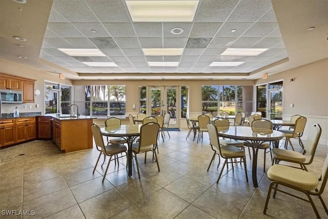 26740 Rosewood Pointe Ln Unit 102, Bonita Springs, FL 34135 - tiled dining space with a drop ceiling, plenty of natural light, french doors, and a sink