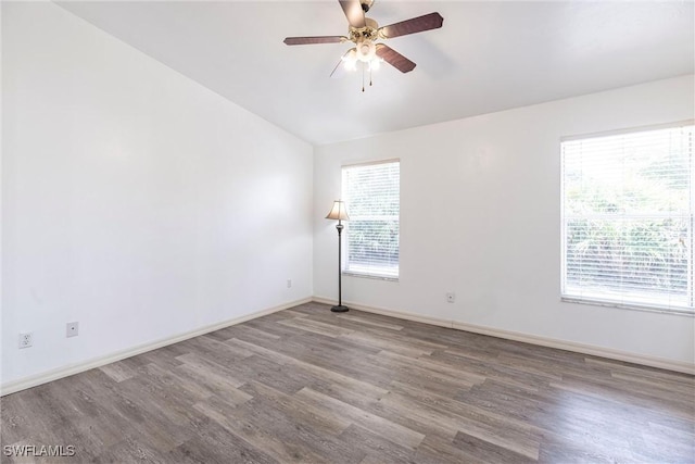 497 Bethany Village Cir, Lehigh Acres, FL 33936 - spare room with wood finished floors, lofted ceiling, a ceiling fan, and baseboards
