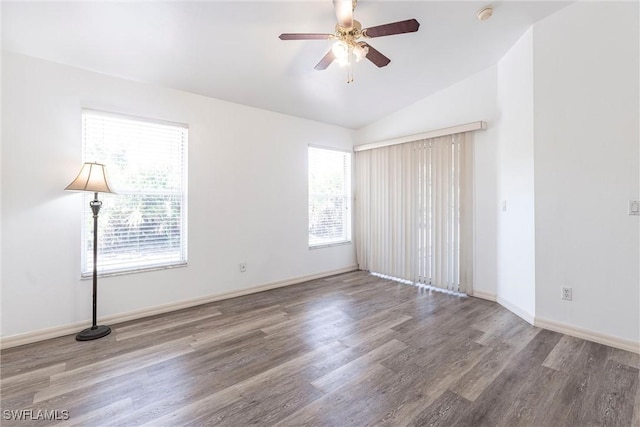 497 Bethany Village Cir, Lehigh Acres, FL 33936 - spare room featuring wood finished floors, ceiling fan, vaulted ceiling, baseboards, and a smoke detector