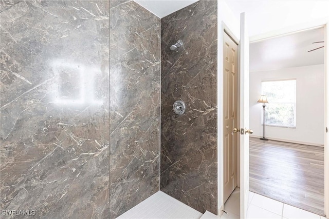 497 Bethany Village Cir, Lehigh Acres, FL 33936 - bathroom featuring a tile shower, ceiling fan, and tile patterned flooring