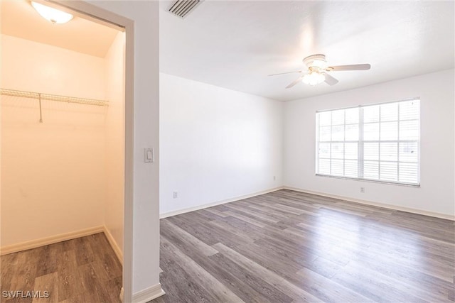 497 Bethany Village Cir, Lehigh Acres, FL 33936 - unfurnished bedroom featuring wood finished floors, baseboards, and a ceiling fan