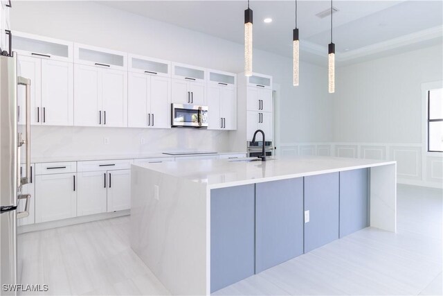 2583 18th Ave SE, Naples, FL 34117 - kitchen with stainless steel appliances, a sink, light countertops, white cabinets, and recessed lighting