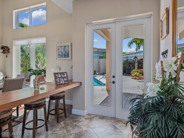 622 Bimini Ave, Marco Island, FL 34145 - doorway with french doors, healthy amount of natural light, baseboards, and tile patterned flooring