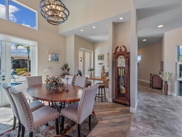 622 Bimini Ave, Marco Island, FL 34145 - dining area with french doors, a chandelier, baseboards, a towering ceiling, and recessed lighting